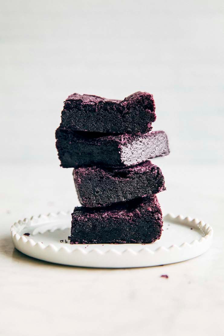 photo showing stack of ube brownies on a small white plate