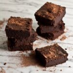 Flourless mocha brownies stacked on a counter