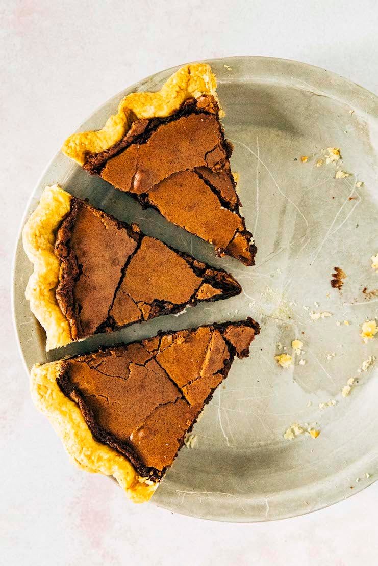 a close up photo of chocolate chess pie slices on a metal pan
