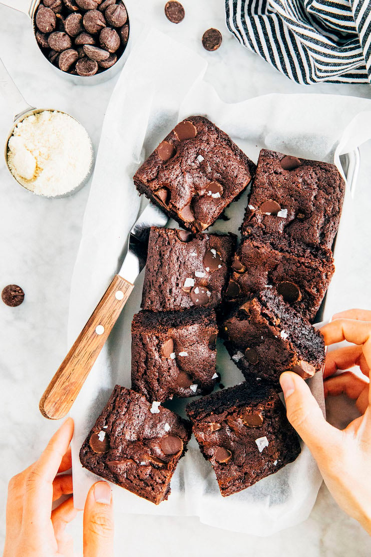 hands reaching for small batch almond flour brownies