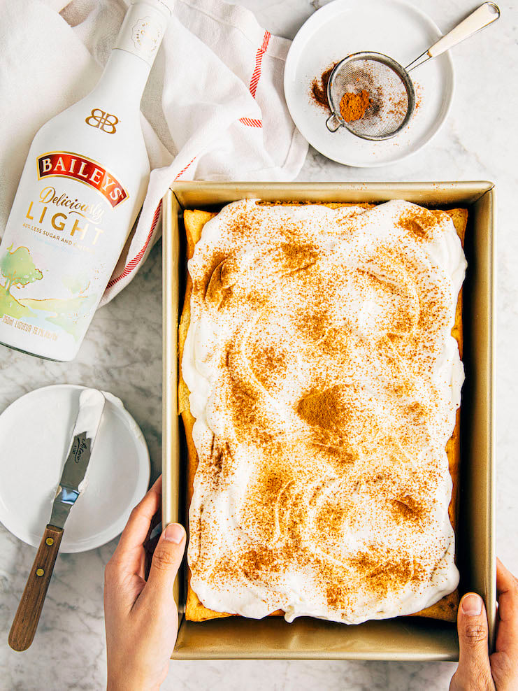 hands presenting baileys tres leches cake