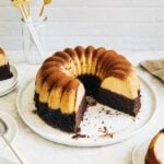 Photo of chocoflan bundt cake on a white plate.