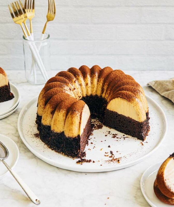 Photo of chocoflan bundt cake on a white plate.