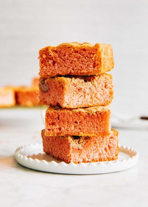 photo of blondies stacked on a white plate