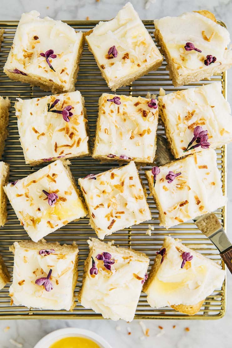photo of coconut cake squares on gold cooling rack