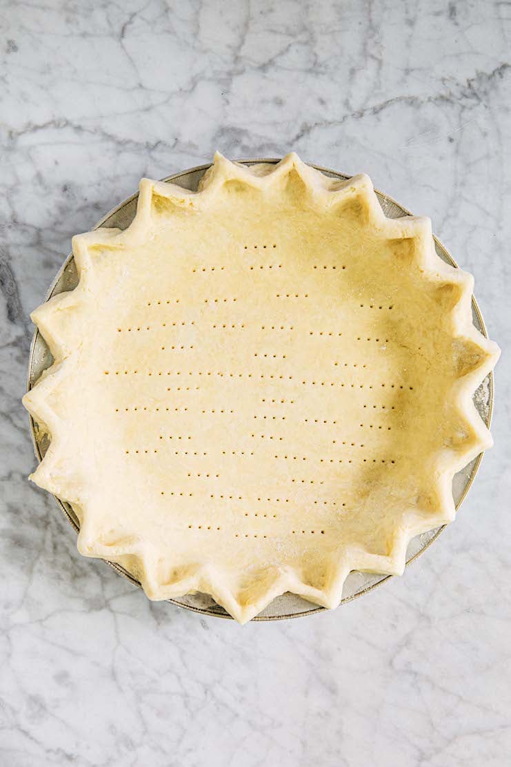 photo of unbaked pie crust on marble backdrop