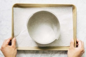 photo of cake ring lined with acetate on sheet pan