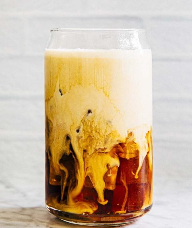 photo of iced coffee with cold foam before stirred
