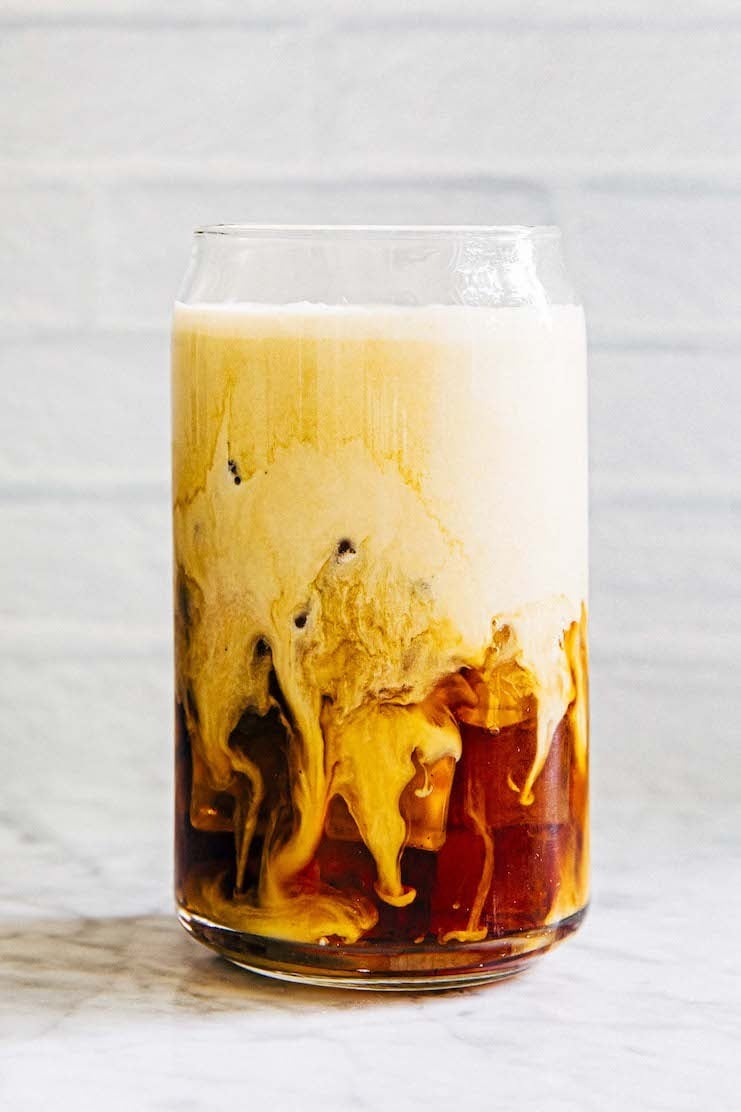 photo of iced coffee with cold foam before stirred