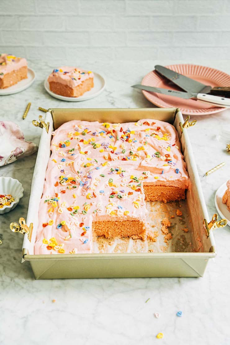 photo of pink sheet cake with slices removed