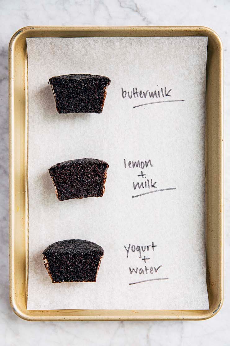 a photo of three chocolate cupcakes made with different buttermilk substitutes sliced crosswise