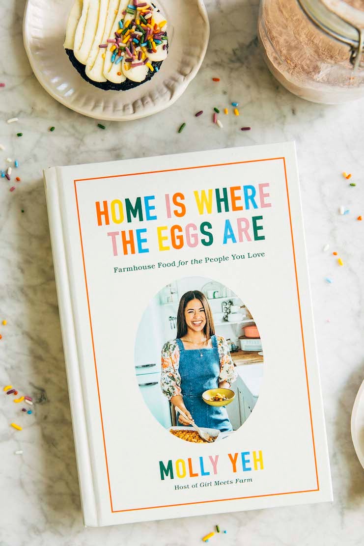 photo of molly yeh's cookbook home is where the eggs are on marble tabletop