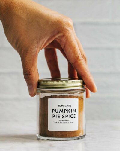 photo of hand setting down a jar of pumpkin pie spice