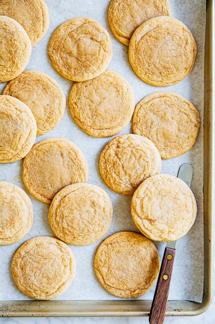 photo of maple sugar cookies on sheet pan with offset spatula