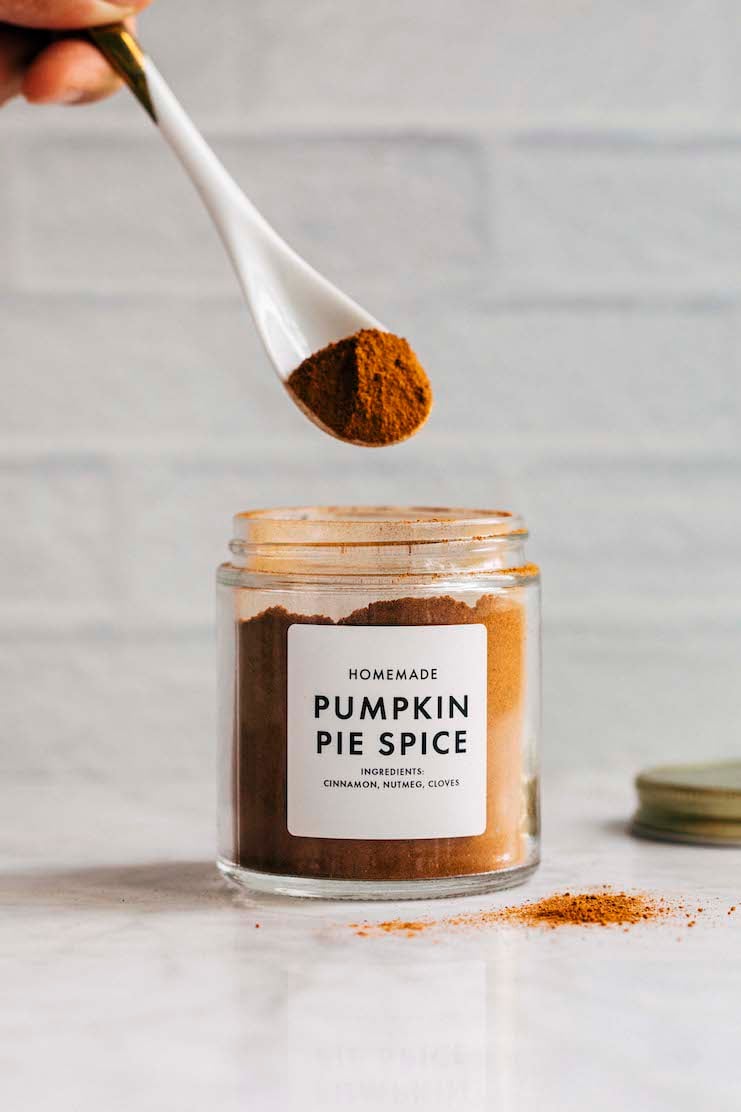 photo of a hand spooning out a mound of pumpkin pie spice