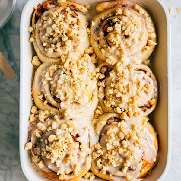 photo of apple pie cinnamon rolls in white baking pan