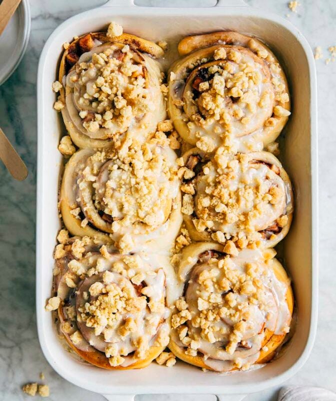 photo of apple pie cinnamon rolls in white baking pan