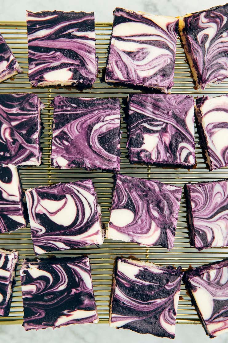photo of sliced ube cheesecake bars on gold wire rack