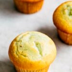 photo of three pistachio pudding muffins on a marble tabletop