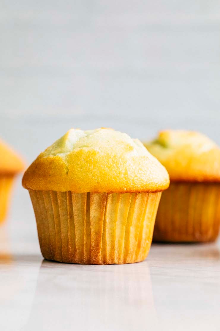 close up photo of pistachio pudding muffin showing their domed muffin tops