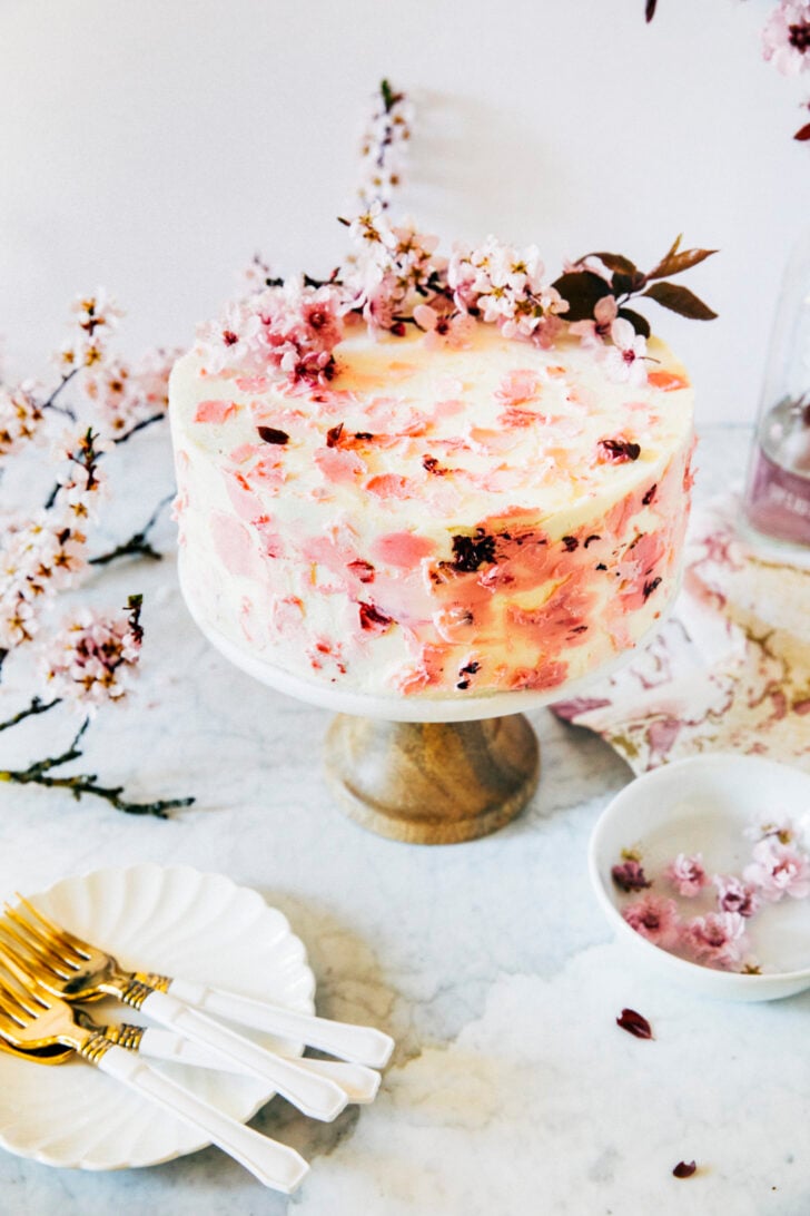 photo of cherry blossom cake showing fresh cherry blossom flowers on top of cake with cherry blossom petal design