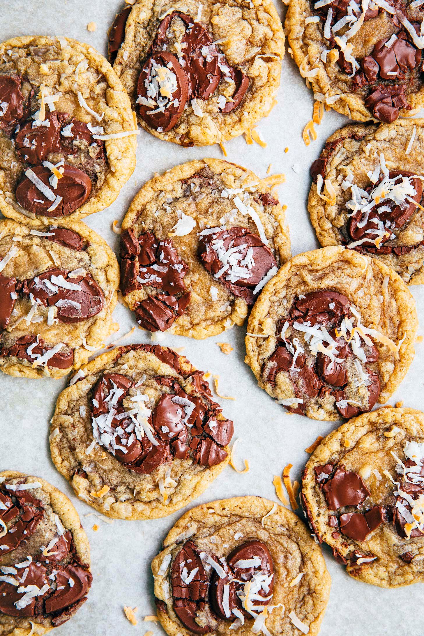 photo of coconut chocolate chip cookies on white parchment paper