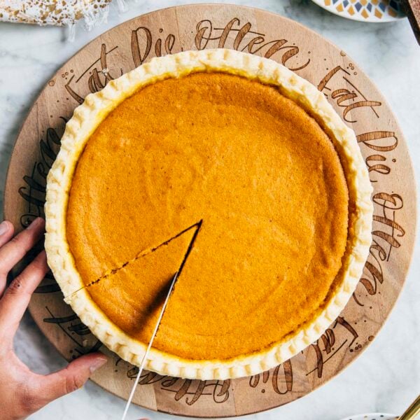 photo of cream cheese pumpkin pie being sliced by michelle of hummingbird high