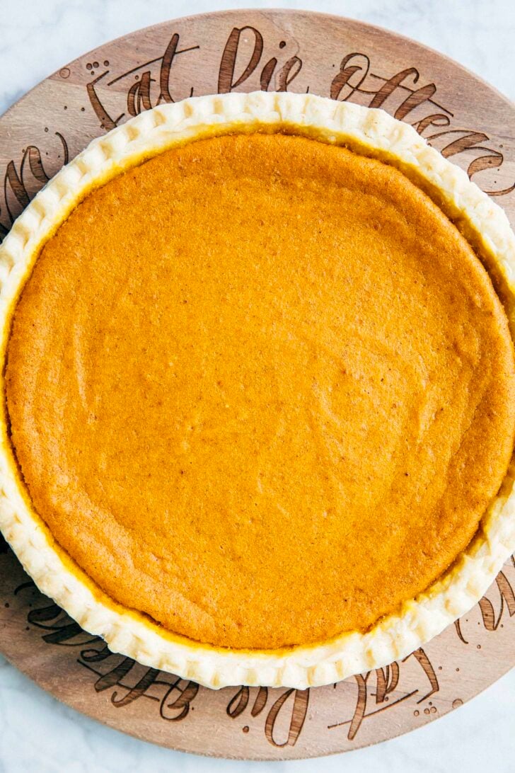 close-up photo of whole cream cheese pumpkin pie before sliced