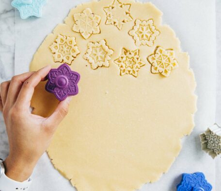 photo of michelle from hummingbird high cutting out sugar cookies from cut out sugar cookie dough