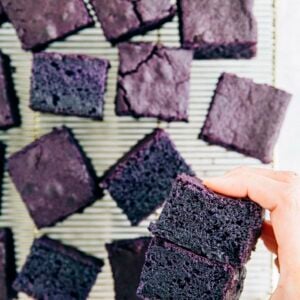 photo of michelle from hummingbird high holding slices of ube mochi cake showing off the crumb