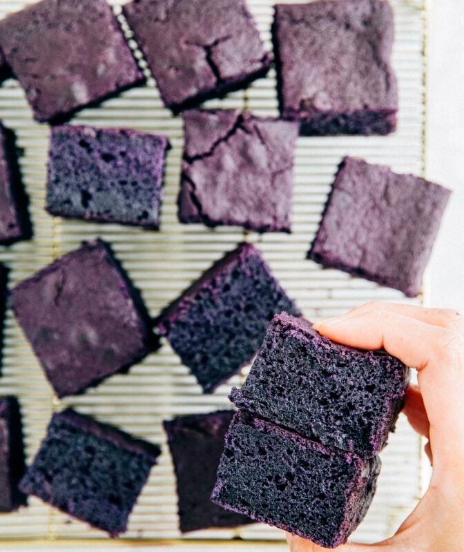 photo of michelle from hummingbird high holding slices of ube mochi cake showing off the crumb