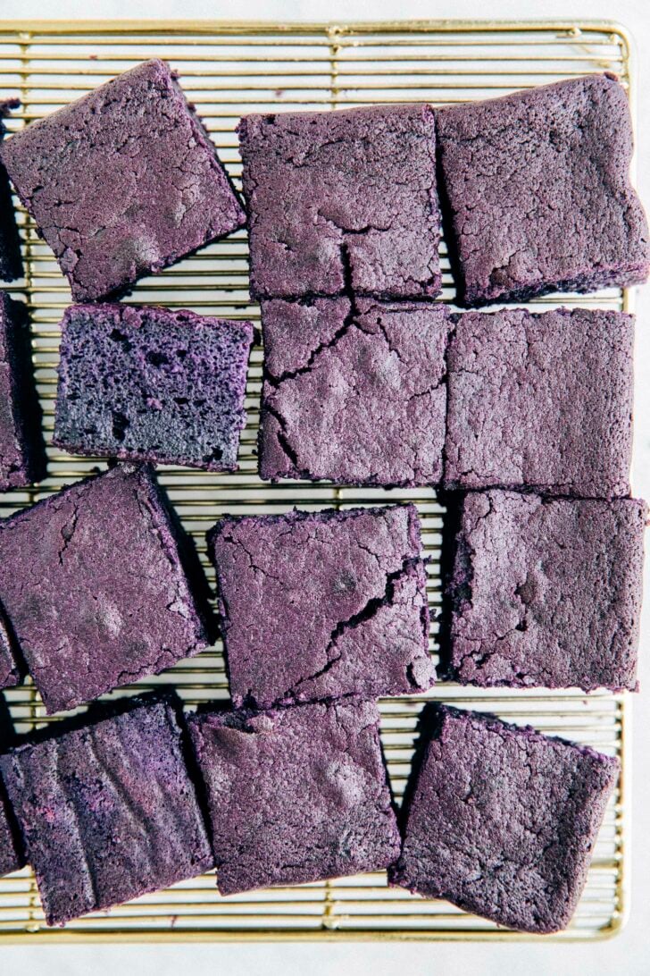 photo of ube mochi cake slices on a gold wire rack