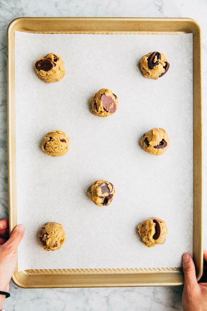 process shot on how to arrange rye chocolate chip cookies on sheet pan for baking