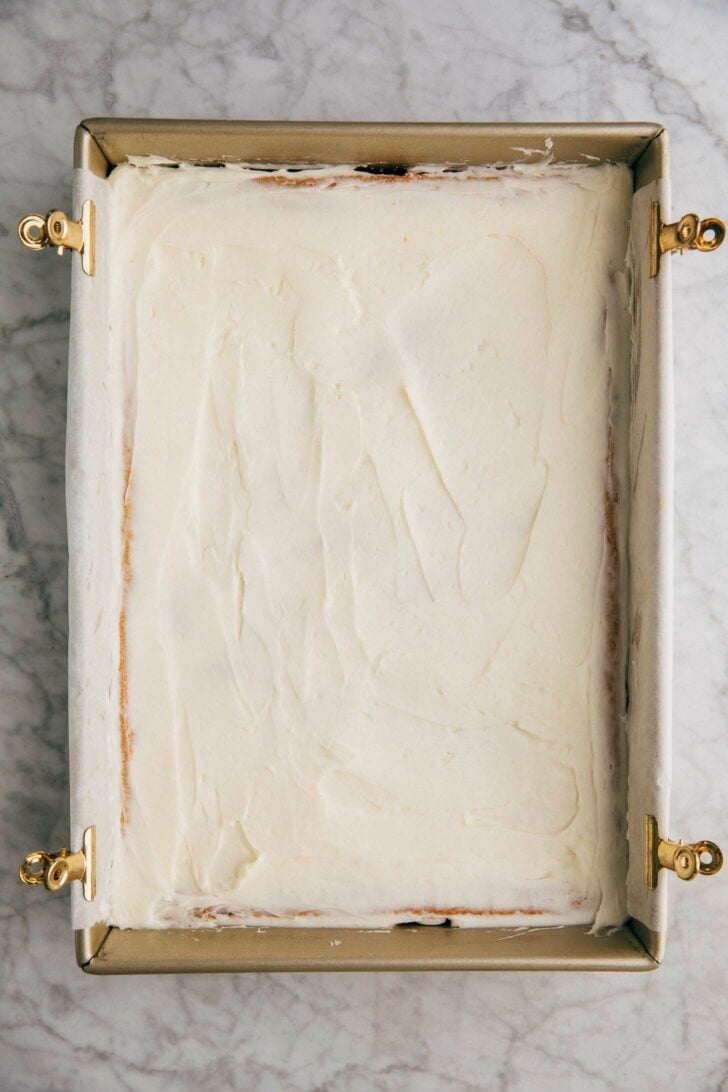 photo of cream cheese frosting spread on top of the pistachio pudding bars