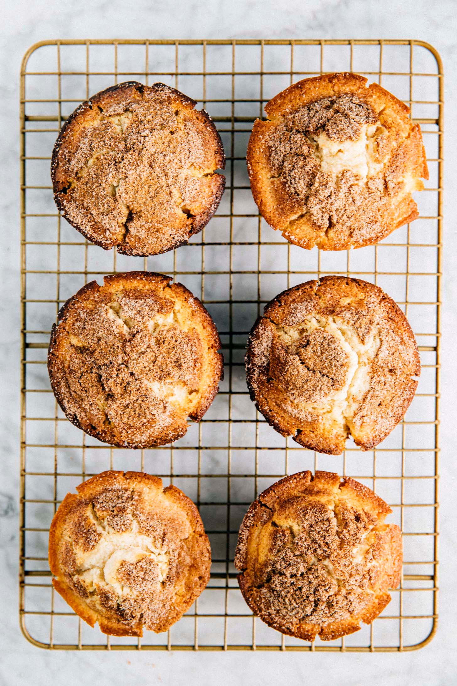photo of 6 snickerdoodle muffins on a gold wire rack