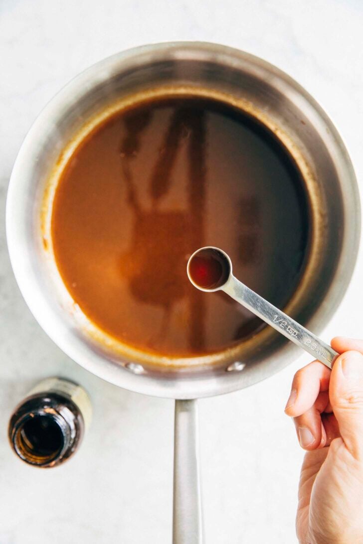 photo of Michelle from hummingbird high adding vanilla extract to the pumpkin spice syrup