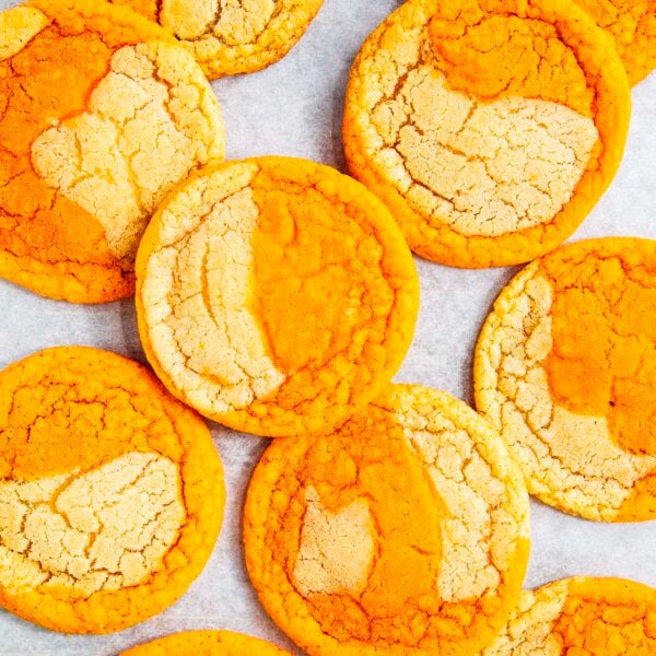 photo of thai tea cookies on a white parchment paper backdrop