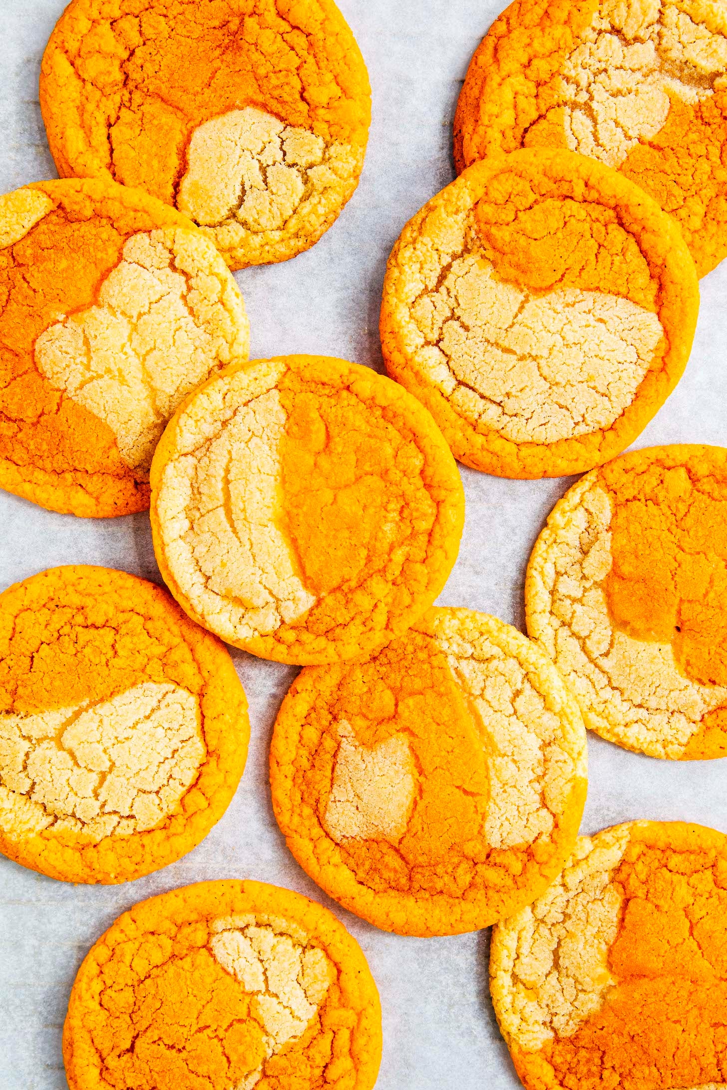 photo of thai tea cookies on a white parchment paper backdrop