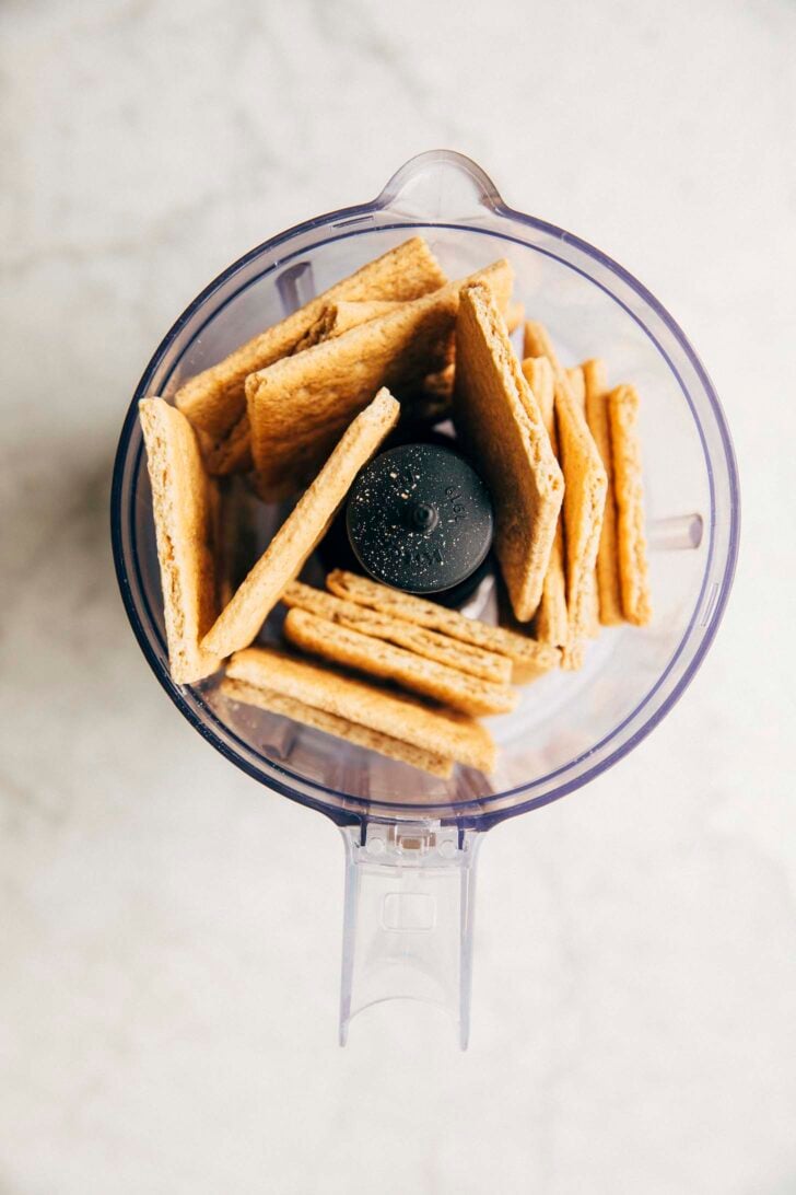 photo of graham crackers in a food processor bowl before being processed into crumbs