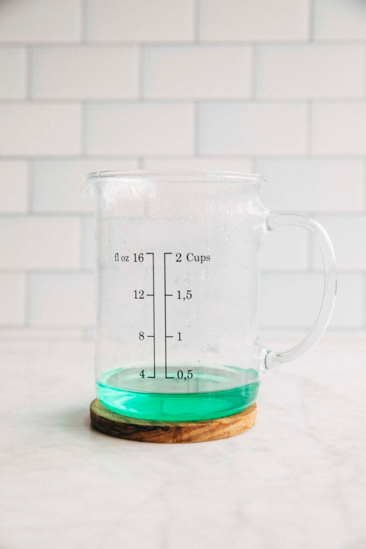 Photo of Mountain Dew Baja Blast in a liquid measuring cup after it's been reduced into the amount needed for Baja Blast pie