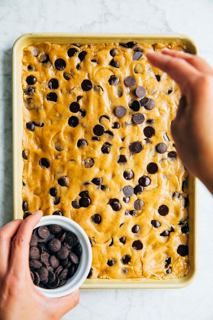 photo of michelle from hummingbird high scattering chocolate chips over the cookie dough