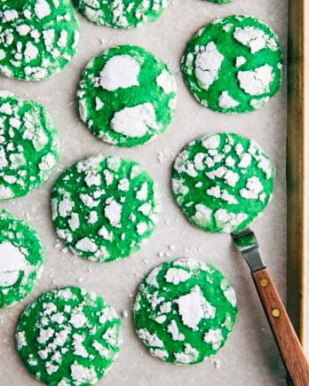 Photo of vibrant green pandan crinkle cookies on a gold sheet pan