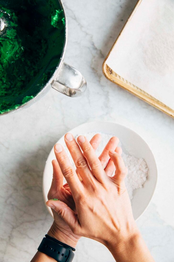 Photo of Michelle from Hummingbird High rolling the pandan cookie dough in between her palms to make a cookie dough ball