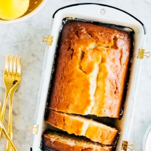 Photo of lemon yogurt loaf slices in a white loaf pan