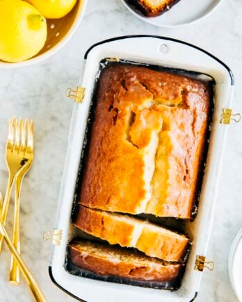 Photo of lemon yogurt loaf slices in a white loaf pan