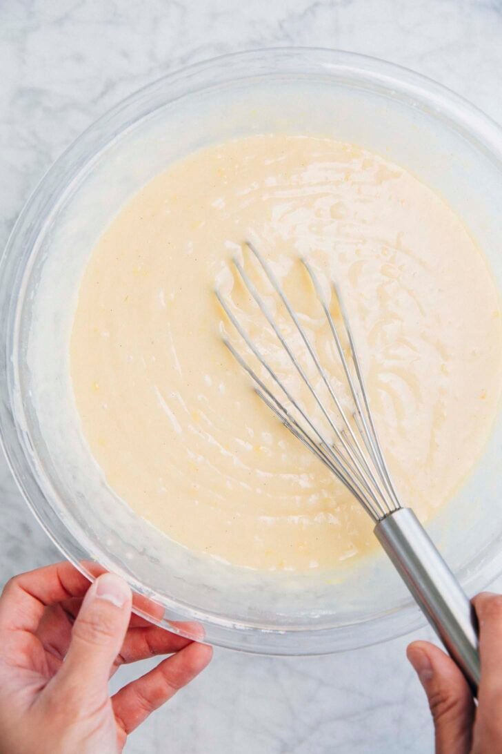 photo of lemon yogurt cake batter in a large clear bowl