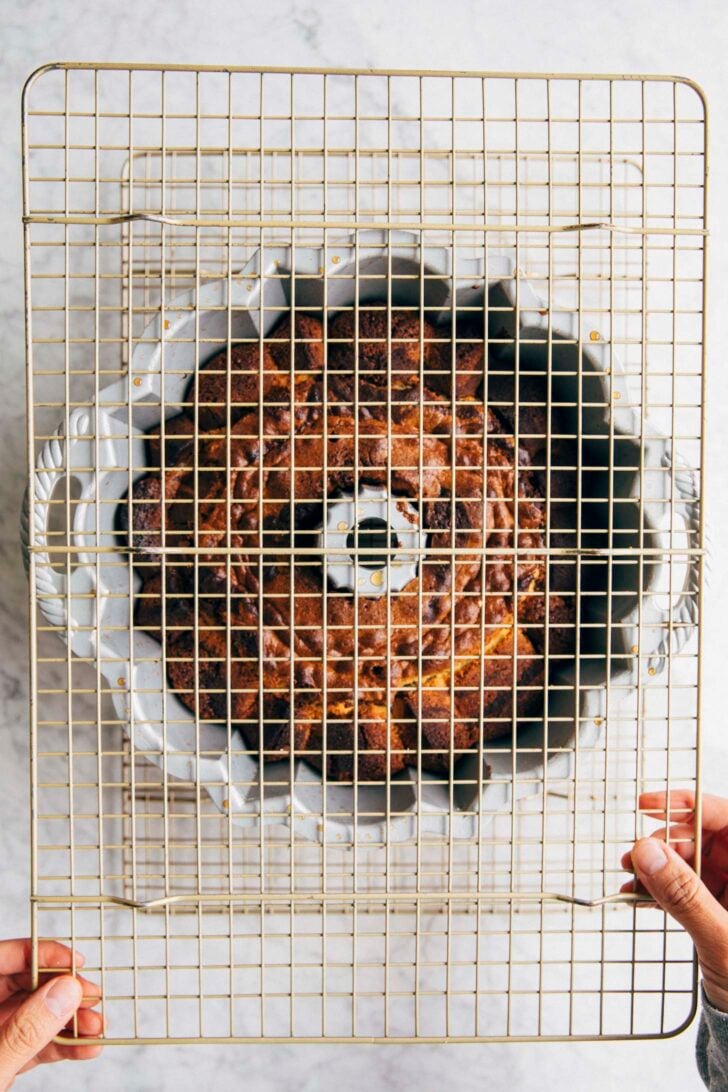 photo of michelle putting a second wire rack on top of the bundt cake