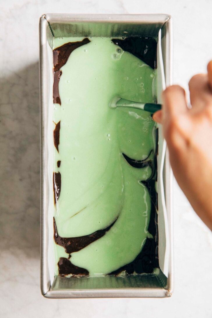 Photo of michelle swirling the layers together with a butter knife