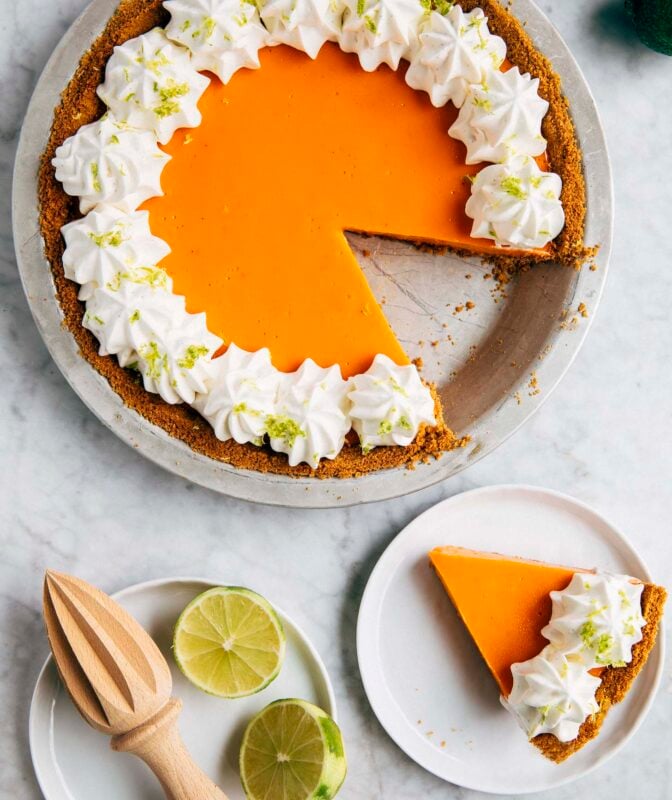 photo of thai tea lime pie with a slice cut out and the slice next to it on a small whitr plate