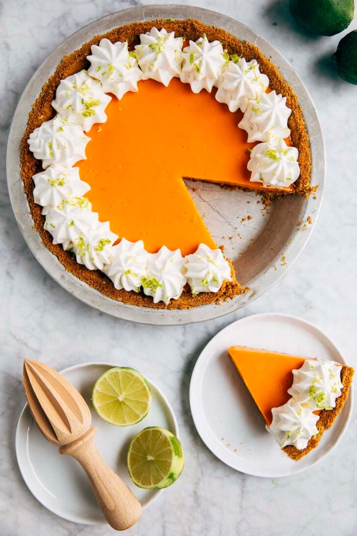 photo of thai tea lime pie with a slice cut out and the slice next to it on a small whitr plate
